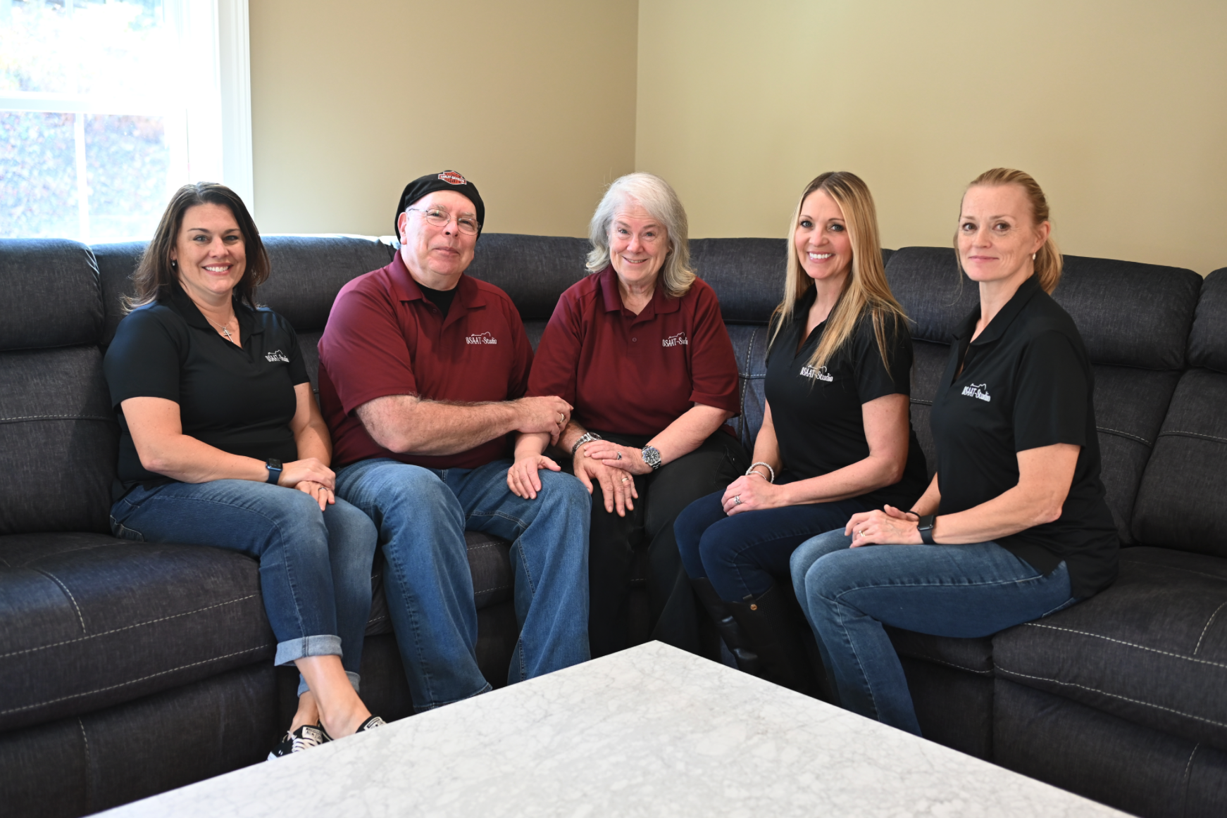 Group of studio personnel sitting on a couch